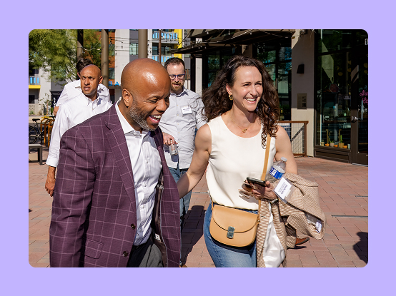 Two AE members walking an smiling
